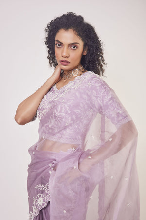 Shop beautiful lilac embroidered organza saree online in USA with designer saree blouse. Make a fashion statement on festive occasions and weddings with designer sarees, designer suits, Indian dresses, Anarkali suits, palazzo suits, designer gowns, sharara suits, embroidered sarees from Pure Elegance Indian fashion store in USA.-closeup