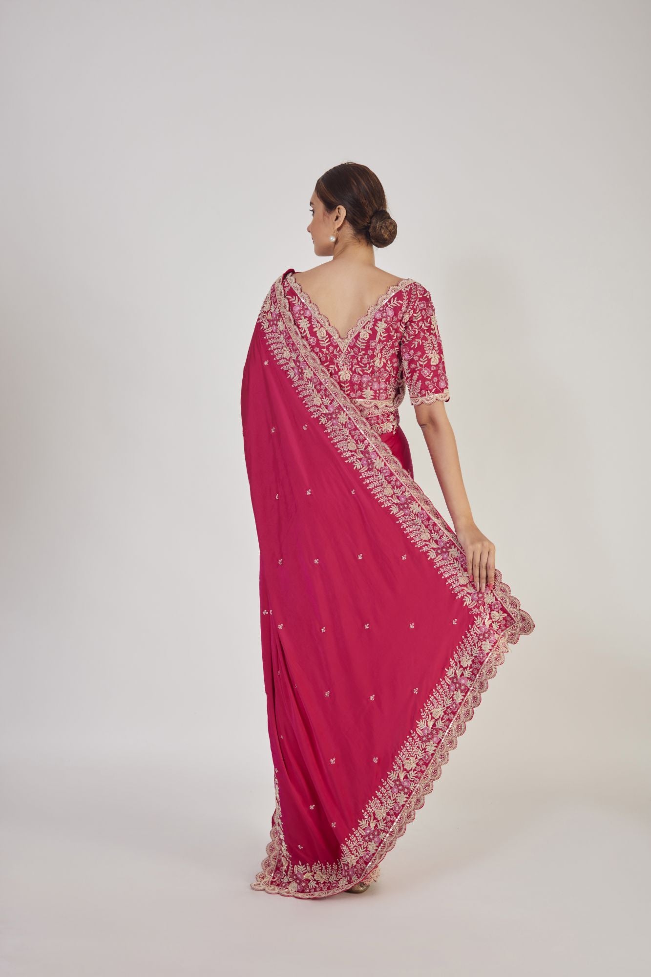 Shop rani pink embroidered raw silk saree online in USA with saree blouse. Make a fashion statement on festive occasions and weddings with designer sarees, designer suits, Indian dresses, Anarkali suits, palazzo suits, designer gowns, sharara suits, embroidered sarees from Pure Elegance Indian fashion store in USA.-back