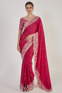Shop rani pink embroidered raw silk saree online in USA with saree blouse. Make a fashion statement on festive occasions and weddings with designer sarees, designer suits, Indian dresses, Anarkali suits, palazzo suits, designer gowns, sharara suits, embroidered sarees from Pure Elegance Indian fashion store in USA.-full view