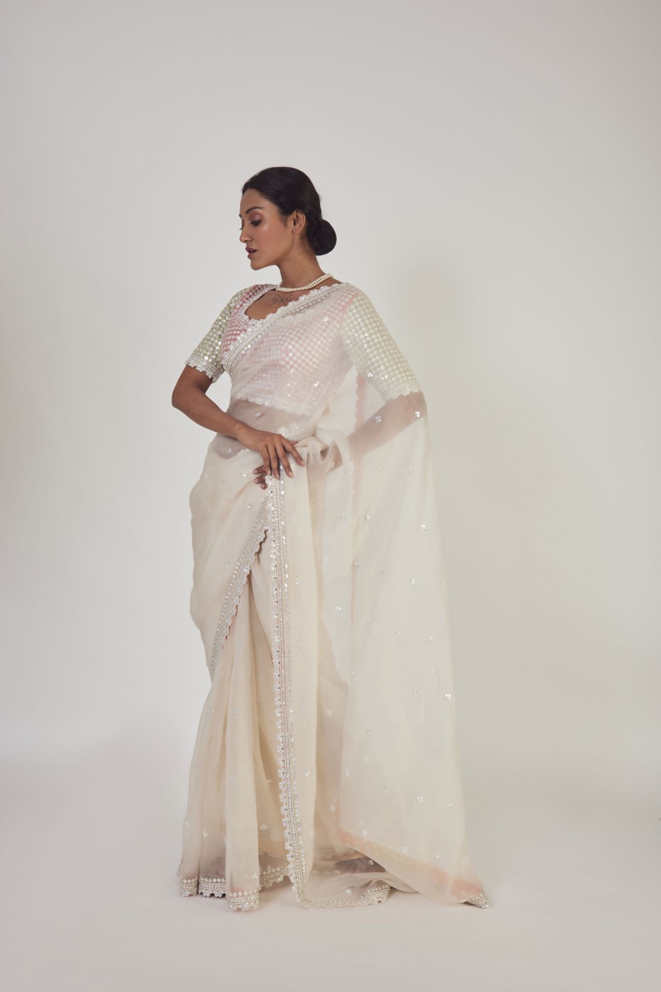 Shop cream embroidered organza saree online in USA with saree blouse. Make a fashion statement on festive occasions and weddings with designer sarees, designer suits, Indian dresses, Anarkali suits, palazzo suits, designer gowns, sharara suits, embroidered sarees from Pure Elegance Indian fashion store in USA.-pallu
