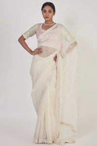 Shop cream embroidered organza saree online in USA with saree blouse. Make a fashion statement on festive occasions and weddings with designer sarees, designer suits, Indian dresses, Anarkali suits, palazzo suits, designer gowns, sharara suits, embroidered sarees from Pure Elegance Indian fashion store in USA.-full view