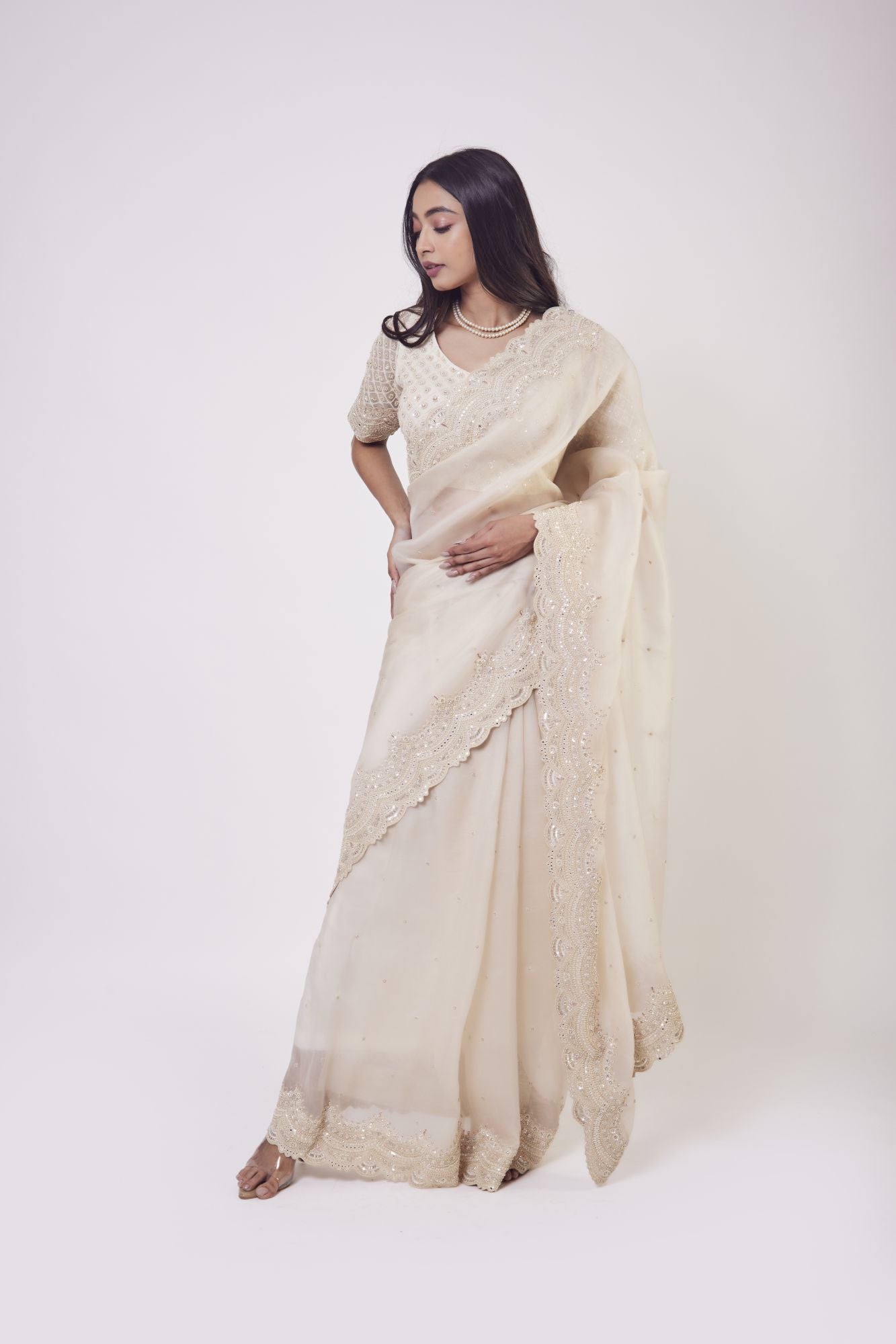 Shop beautiful cream embroidered organza saree online in USA with saree blouse. Make a fashion statement on festive occasions and weddings with designer sarees, designer suits, Indian dresses, Anarkali suits, palazzo suits, designer gowns, sharara suits, embroidered sarees from Pure Elegance Indian fashion store in USA.-front