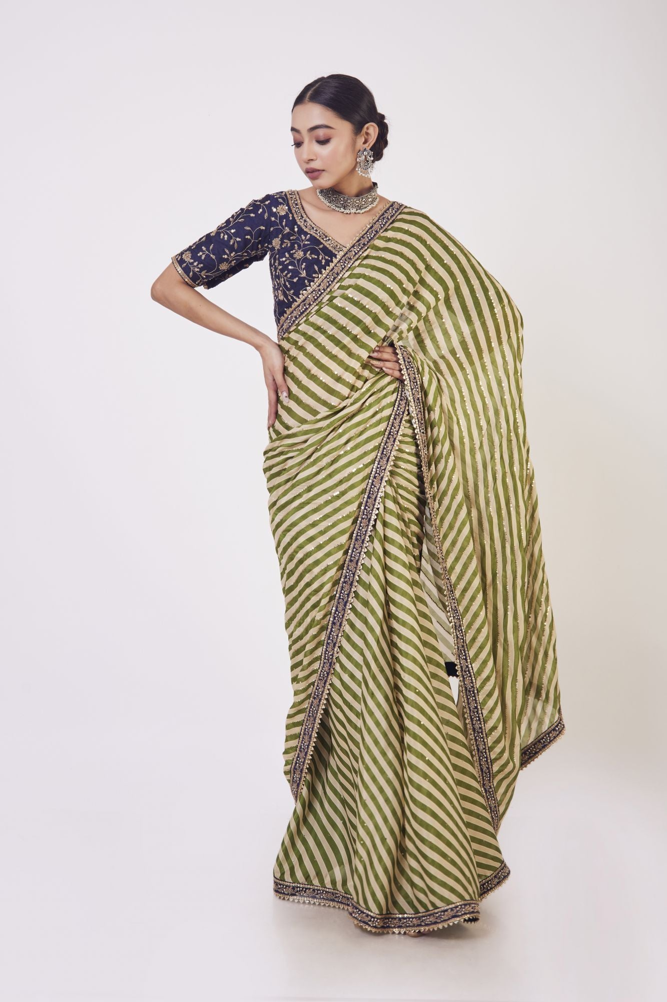 Shop green leheriya chiffon saree online in USA with resham work. Make a fashion statement on festive occasions and weddings with designer sarees, designer suits, Indian dresses, Anarkali suits, palazzo suits, designer gowns, sharara suits, embroidered sarees from Pure Elegance Indian fashion store in USA.-front
