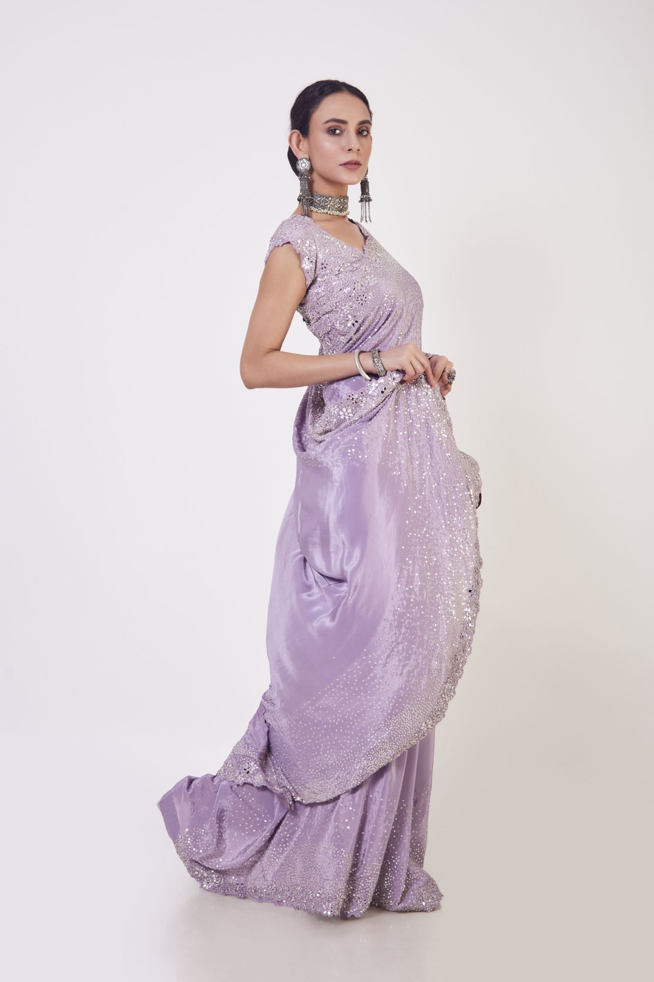 Buy beautiful lilac sequin and mirror work crepe saree online in USA. Make a fashion statement on festive occasions and weddings with designer sarees, designer suits, Indian dresses, Anarkali suits, palazzo suits, designer gowns, sharara suits, embroidered sarees from Pure Elegance Indian fashion store in USA.-side