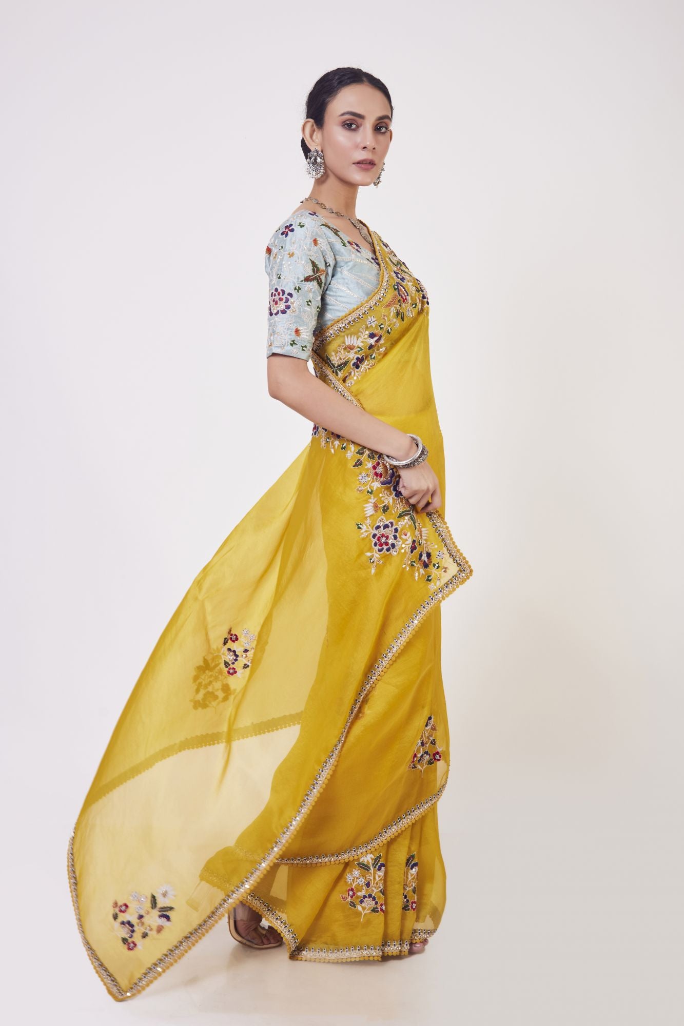 Shop mustard embroidered organza sari online in USA with grey blouse. Make a fashion statement on festive occasions and weddings with designer sarees, designer suits, Indian dresses, Anarkali suits, palazzo suits, designer gowns, sharara suits, embroidered sarees from Pure Elegance Indian fashion store in USA.-side