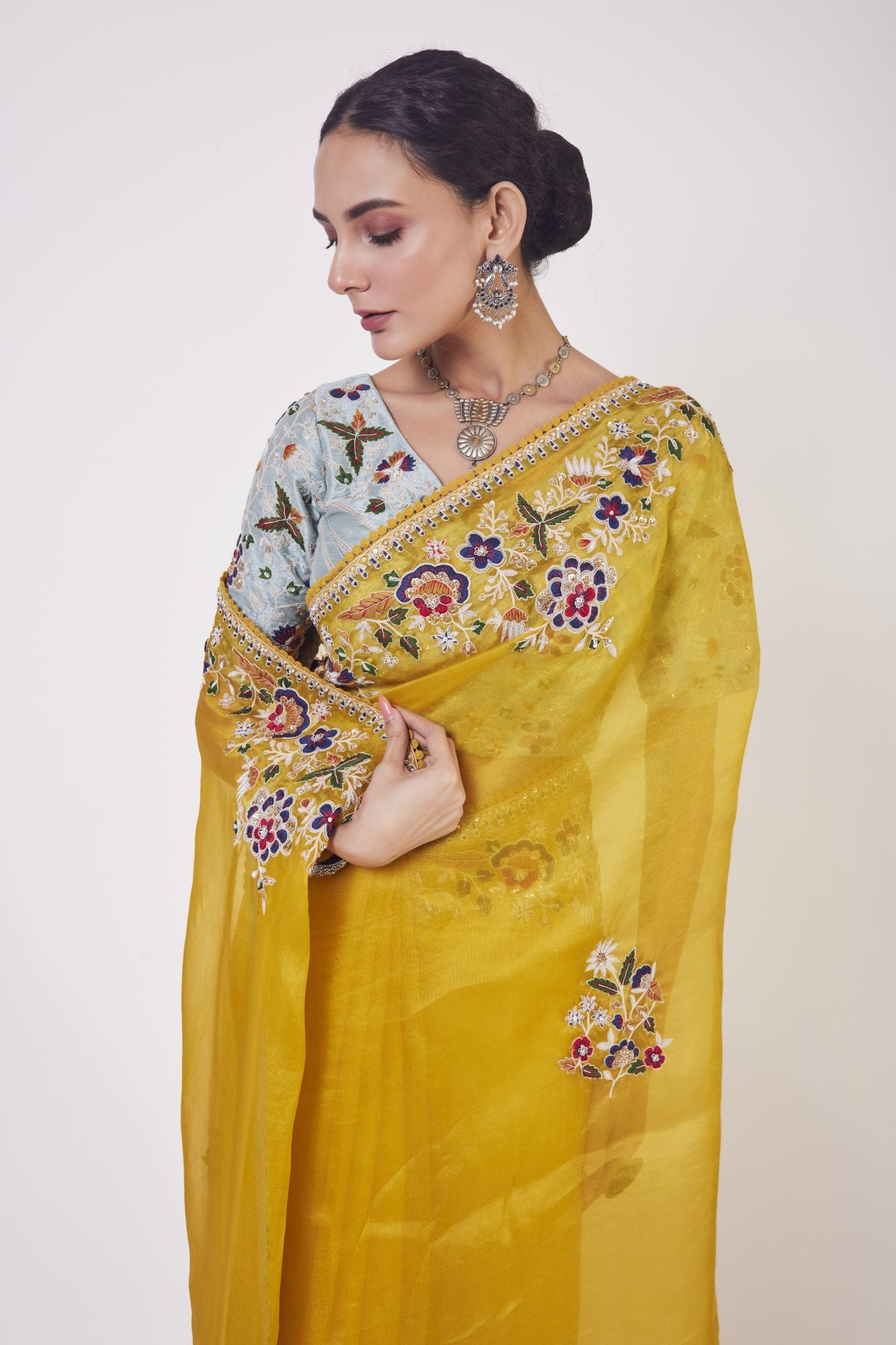 Shop mustard embroidered organza sari online in USA with grey blouse. Make a fashion statement on festive occasions and weddings with designer sarees, designer suits, Indian dresses, Anarkali suits, palazzo suits, designer gowns, sharara suits, embroidered sarees from Pure Elegance Indian fashion store in USA.-closeup