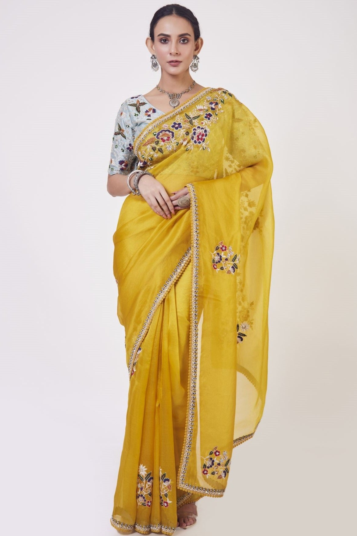 Shop mustard embroidered organza sari online in USA with grey blouse. Make a fashion statement on festive occasions and weddings with designer sarees, designer suits, Indian dresses, Anarkali suits, palazzo suits, designer gowns, sharara suits, embroidered sarees from Pure Elegance Indian fashion store in USA.-full view