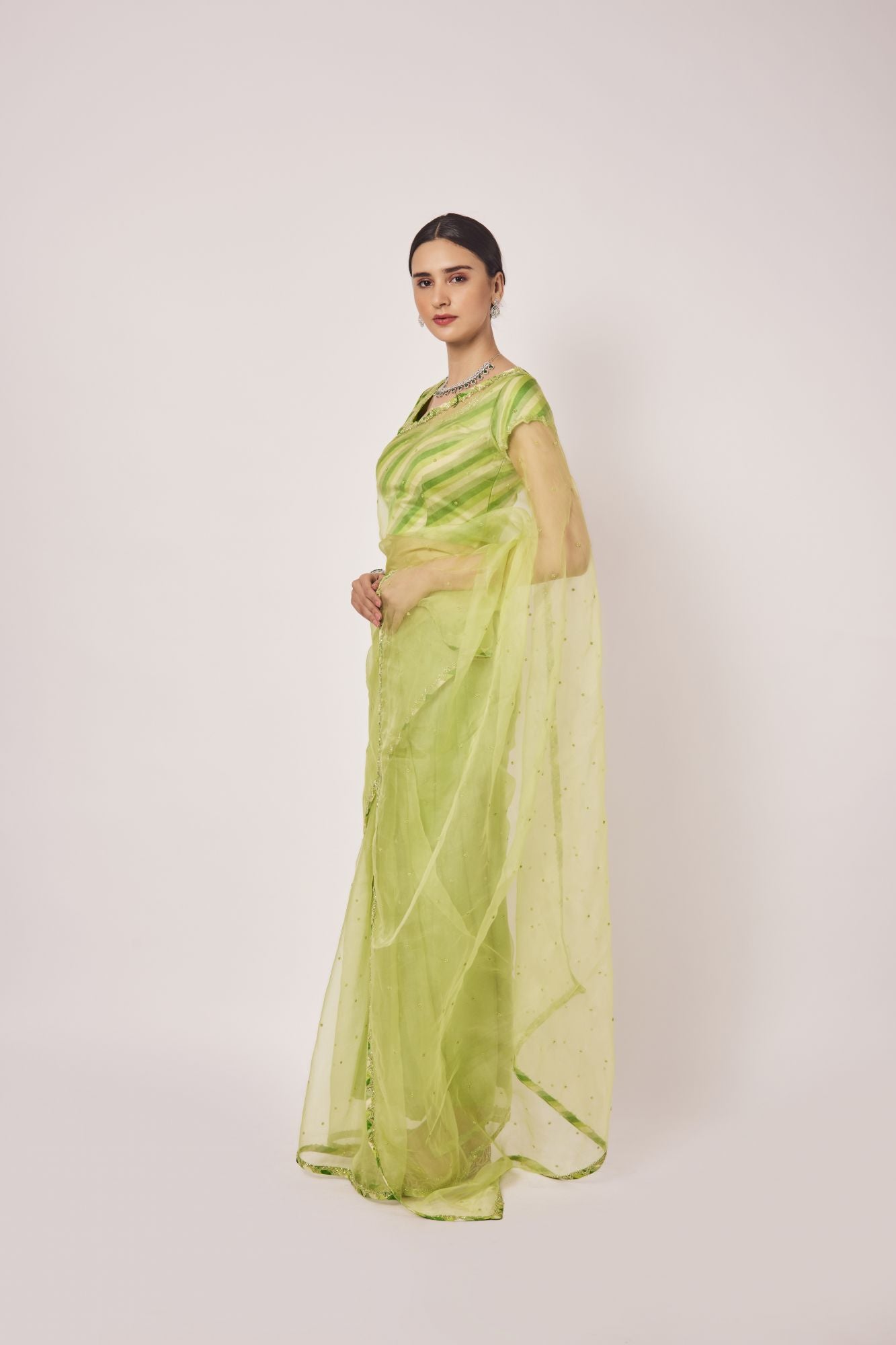 Buy pista green cutdana and pearl work organza sari online in USA. Make a fashion statement on festive occasions and weddings with designer sarees, designer suits, Indian dresses, Anarkali suits, palazzo suits, designer gowns, sharara suits, embroidered sarees from Pure Elegance Indian fashion store in USA.-pallu