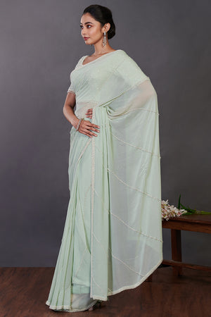 Shop mint green embroidered georgette sari online in USA with blouse. Make a fashion statement on festive occasions and weddings with designer sarees, designer suits, Indian dresses, Anarkali suits, palazzo suits, designer gowns, sharara suits, embroidered sarees from Pure Elegance Indian fashion store in USA.-pallu