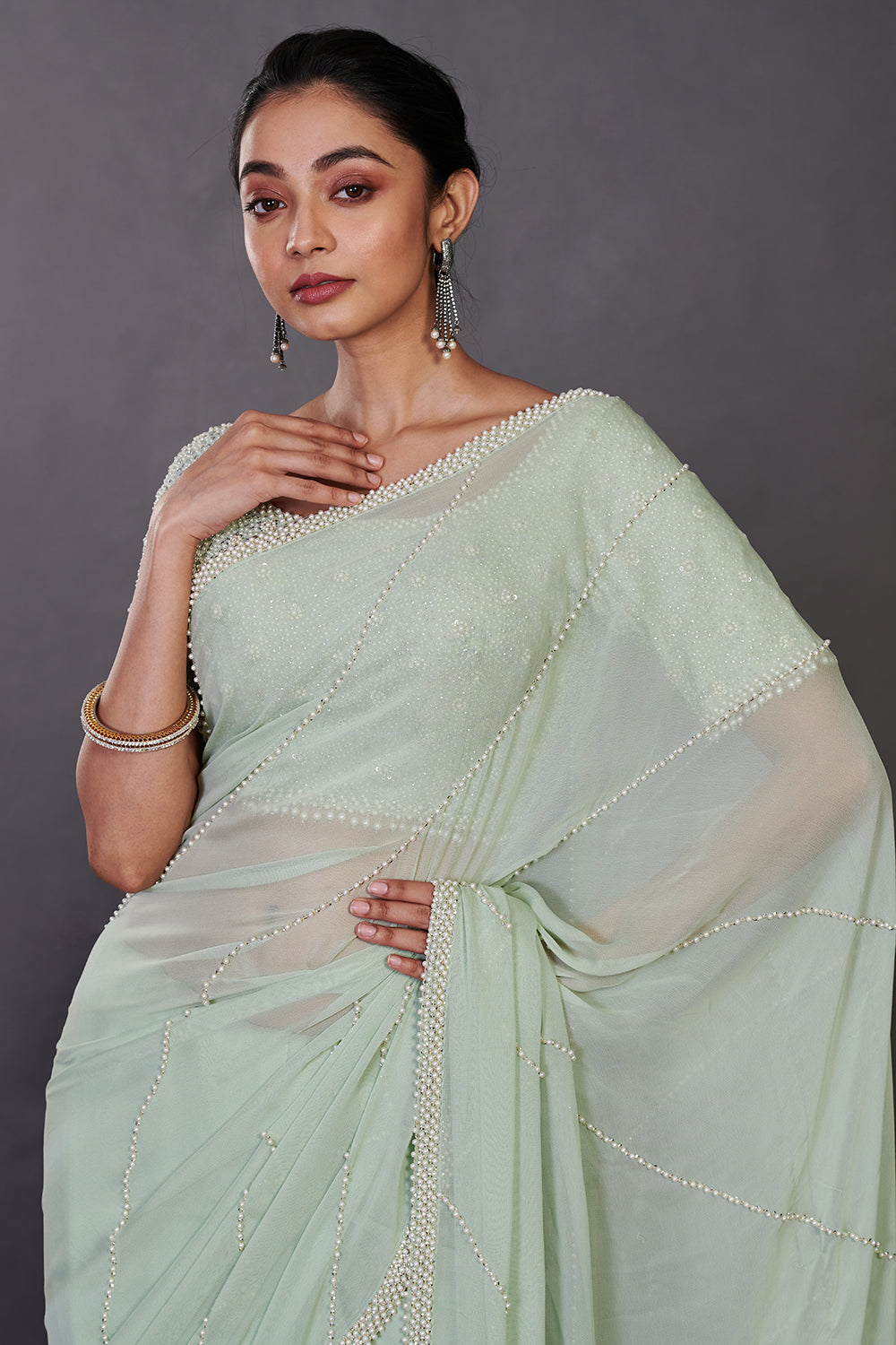 Shop mint green embroidered georgette sari online in USA with blouse. Make a fashion statement on festive occasions and weddings with designer sarees, designer suits, Indian dresses, Anarkali suits, palazzo suits, designer gowns, sharara suits, embroidered sarees from Pure Elegance Indian fashion store in USA.-closeup