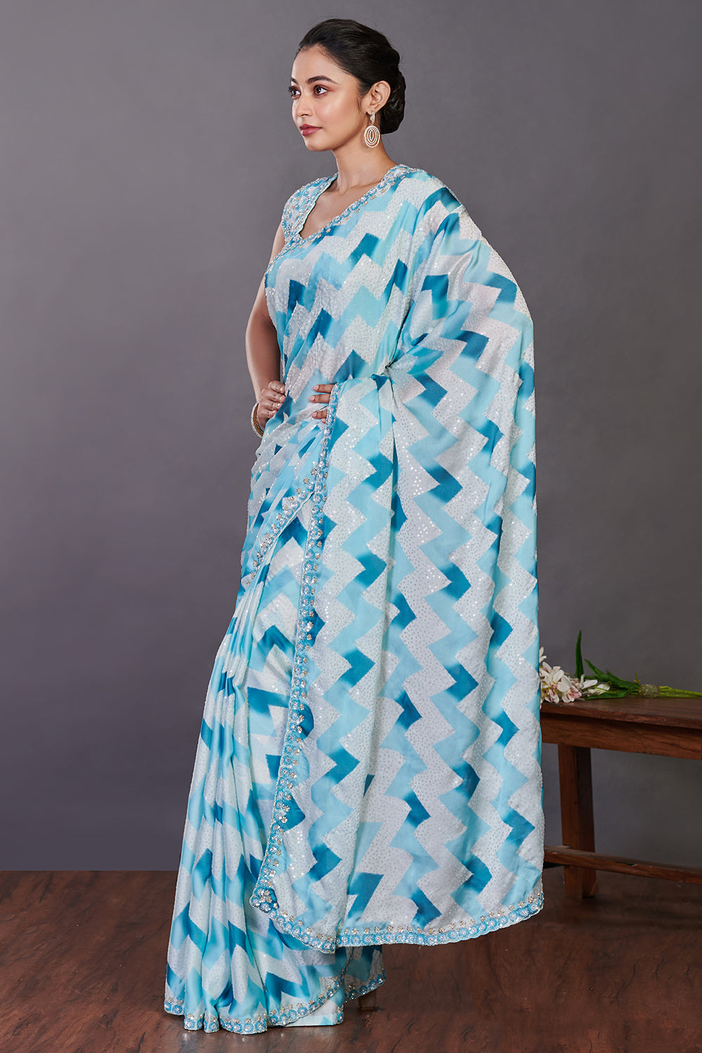 Buy aqua blue printed satin sequin work sari online in USA with blouse. Make a fashion statement on festive occasions and weddings with designer sarees, designer suits, Indian dresses, Anarkali suits, palazzo suits, designer gowns, sharara suits, embroidered sarees from Pure Elegance Indian fashion store in USA.-left