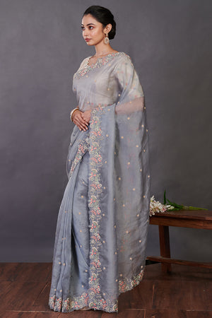 Shop beautiful grey hand embroidered organza sari online in USA with blouse. Make a fashion statement on festive occasions and weddings with designer sarees, designer suits, Indian dresses, Anarkali suits, palazzo suits, designer gowns, sharara suits, embroidered sarees from Pure Elegance Indian fashion store in USA.-pallu