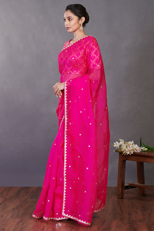Buy stunning rani pink embroidered organza sari online in USA with blouse. Make a fashion statement on festive occasions and weddings with designer sarees, designer suits, Indian dresses, Anarkali suits, palazzo suits, designer gowns, sharara suits, embroidered sarees from Pure Elegance Indian fashion store in USA.-pallu