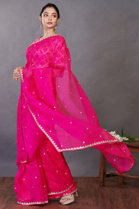 Buy stunning rani pink embroidered organza sari online in USA with blouse. Make a fashion statement on festive occasions and weddings with designer sarees, designer suits, Indian dresses, Anarkali suits, palazzo suits, designer gowns, sharara suits, embroidered sarees from Pure Elegance Indian fashion store in USA.-full view