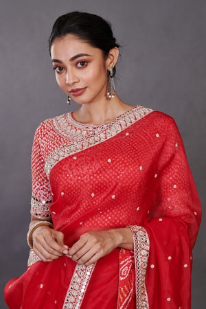 Shop red mirror work organza sari online in USA with designer blouse. Make a fashion statement on festive occasions and weddings with designer sarees, designer suits, Indian dresses, Anarkali suits, palazzo suits, designer gowns, sharara suits, embroidered sarees from Pure Elegance Indian fashion store in USA.-closeup