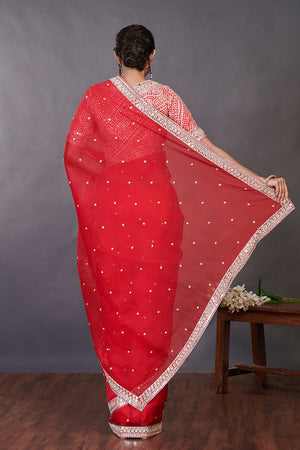 Shop red mirror work organza sari online in USA with designer blouse. Make a fashion statement on festive occasions and weddings with designer sarees, designer suits, Indian dresses, Anarkali suits, palazzo suits, designer gowns, sharara suits, embroidered sarees from Pure Elegance Indian fashion store in USA.-back