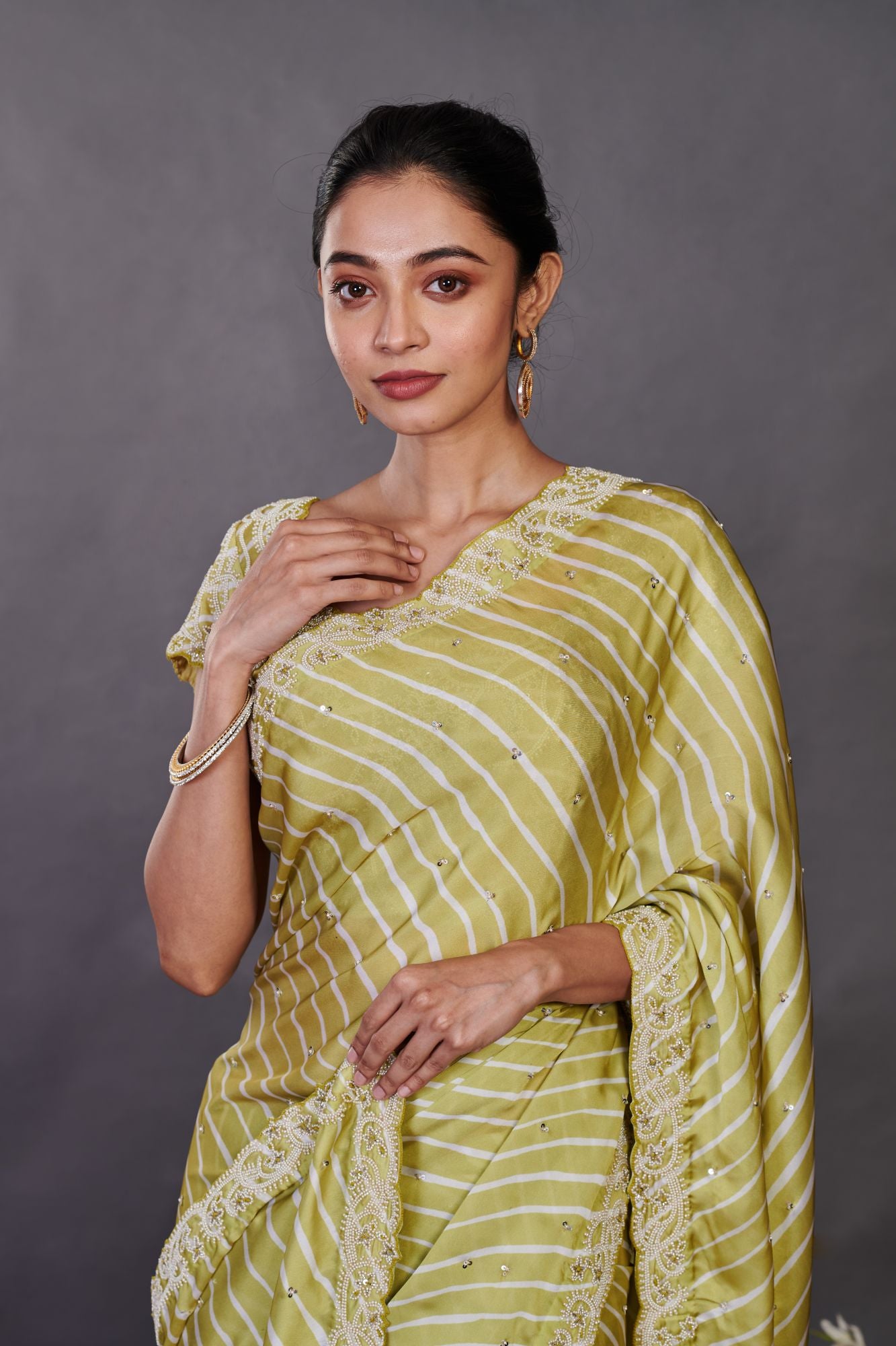 Buy beautiful pista green printed satin sari online in USA with bead work. Make a fashion statement on festive occasions and weddings with designer sarees, designer suits, Indian dresses, Anarkali suits, palazzo suits, designer gowns, sharara suits, embroidered sarees from Pure Elegance Indian fashion store in USA.-closeup