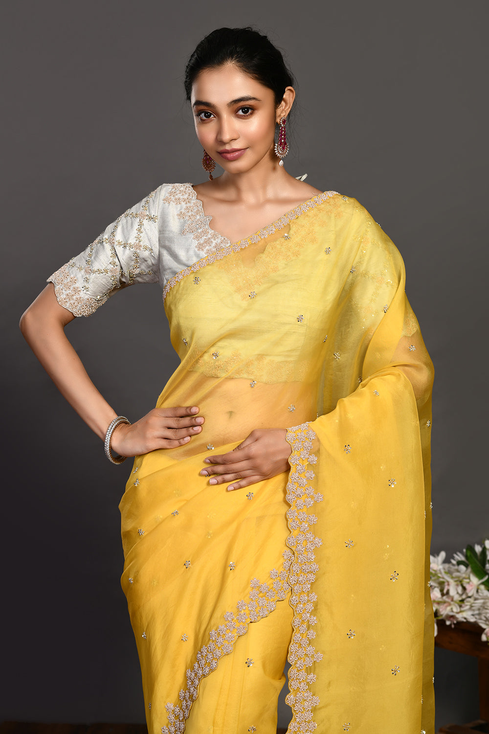 Buy beautiful yellow hand embroidered organza sari online in USA with bead work. Make a fashion statement on festive occasions and weddings with designer sarees, designer suits, Indian dresses, Anarkali suits, palazzo suits, designer gowns, sharara suits, embroidered sarees from Pure Elegance Indian fashion store in USA.-closeup