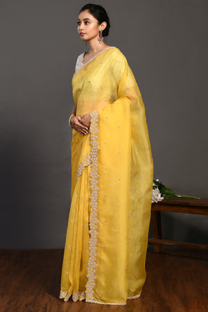 Buy beautiful yellow hand embroidered organza sari online in USA with bead work. Make a fashion statement on festive occasions and weddings with designer sarees, designer suits, Indian dresses, Anarkali suits, palazzo suits, designer gowns, sharara suits, embroidered sarees from Pure Elegance Indian fashion store in USA.-pallu