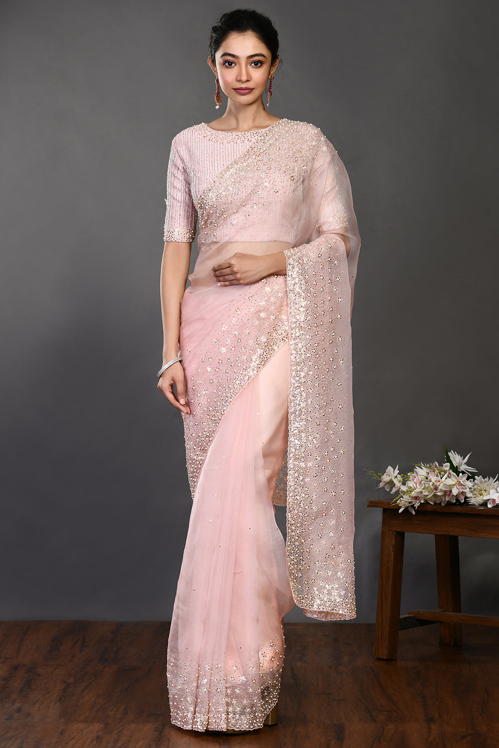 Shop powder pink embroidered organza sari online in USA with blouse. Make a fashion statement on festive occasions and weddings with designer sarees, designer suits, Indian dresses, Anarkali suits, palazzo suits, designer gowns, sharara suits, embroidered sarees from Pure Elegance Indian fashion store in USA.-full view