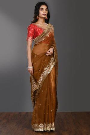 Buy brown tikki work organza sari online in USA with kiran lace and blouse. Make a fashion statement on festive occasions and weddings with designer sarees, designer suits, Indian dresses, Anarkali suits, palazzo suits, designer gowns, sharara suits, embroidered sarees from Pure Elegance Indian fashion store in USA.-side