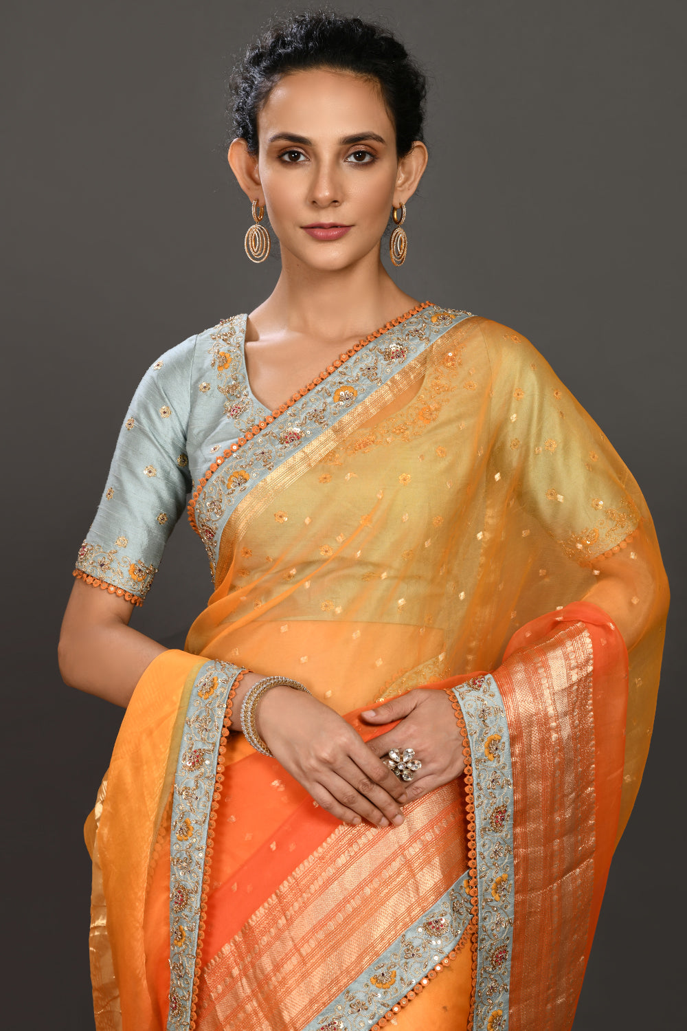 Buy yellow and orange hand embroidered organza sari online in USA with grey blouse. Make a fashion statement on festive occasions and weddings with designer sarees, designer suits, Indian dresses, Anarkali suits, palazzo suits, designer gowns, sharara suits, embroidered sarees from Pure Elegance Indian fashion store in USA.-closeup