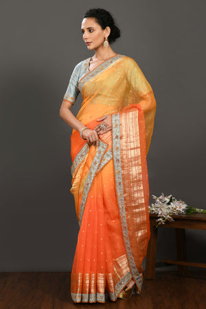 Buy yellow and orange hand embroidered organza sari online in USA with grey blouse. Make a fashion statement on festive occasions and weddings with designer sarees, designer suits, Indian dresses, Anarkali suits, palazzo suits, designer gowns, sharara suits, embroidered sarees from Pure Elegance Indian fashion store in USA.-pallu