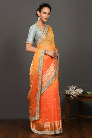 Buy yellow and orange hand embroidered organza sari online in USA with grey blouse. Make a fashion statement on festive occasions and weddings with designer sarees, designer suits, Indian dresses, Anarkali suits, palazzo suits, designer gowns, sharara suits, embroidered sarees from Pure Elegance Indian fashion store in USA.-right
