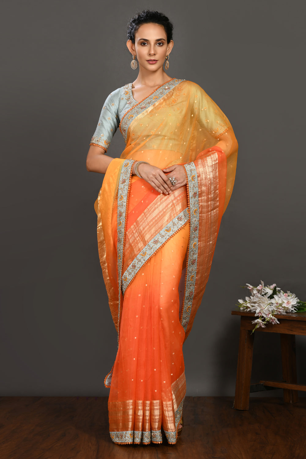 Buy yellow and orange hand embroidered organza sari online in USA with grey blouse. Make a fashion statement on festive occasions and weddings with designer sarees, designer suits, Indian dresses, Anarkali suits, palazzo suits, designer gowns, sharara suits, embroidered sarees from Pure Elegance Indian fashion store in USA.-full view