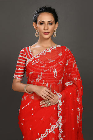 Shop red embroidered georgette sari online in USA with blouse. Make a fashion statement on festive occasions and weddings with designer sarees, designer suits, Indian dresses, Anarkali suits, palazzo suits, designer gowns, sharara suits, embroidered sarees from Pure Elegance Indian fashion store in USA.-closeup
