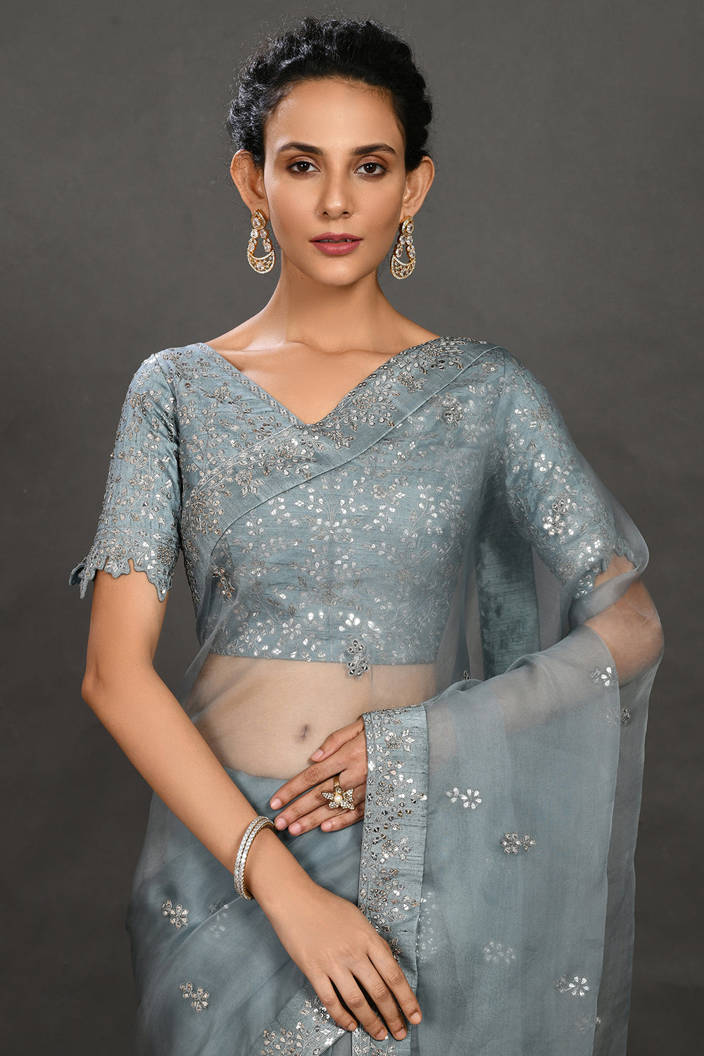 Shop teal blue embroidered organza sari online in USA with blouse. Make a fashion statement on festive occasions and weddings with designer sarees, designer suits, Indian dresses, Anarkali suits, palazzo suits, designer gowns, sharara suits, embroidered sarees from Pure Elegance Indian fashion store in USA.-closeup