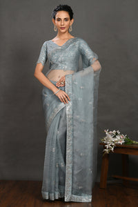 Shop teal blue embroidered organza sari online in USA with blouse. Make a fashion statement on festive occasions and weddings with designer sarees, designer suits, Indian dresses, Anarkali suits, palazzo suits, designer gowns, sharara suits, embroidered sarees from Pure Elegance Indian fashion store in USA.-full view