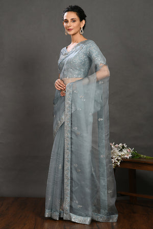 Shop teal blue embroidered organza sari online in USA with blouse. Make a fashion statement on festive occasions and weddings with designer sarees, designer suits, Indian dresses, Anarkali suits, palazzo suits, designer gowns, sharara suits, embroidered sarees from Pure Elegance Indian fashion store in USA.-pallu
