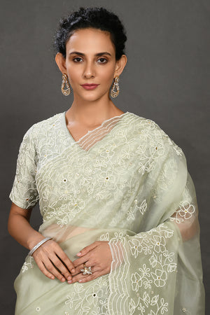 Shop pista green pearl and mirror work organza sari online in USA with blouse. Make a fashion statement on festive occasions and weddings with designer sarees, designer suits, Indian dresses, Anarkali suits, palazzo suits, designer gowns, sharara suits, embroidered sarees from Pure Elegance Indian fashion store in USA.-closeup