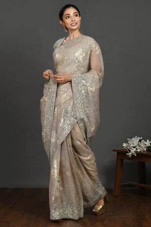 Buy grey stone and cutdana work organza sari online in USA with blouse. Make a fashion statement on festive occasions and weddings with designer sarees, designer suits, Indian dresses, Anarkali suits, palazzo suits, designer gowns, sharara suits, embroidered sarees from Pure Elegance Indian fashion store in USA.-pallu