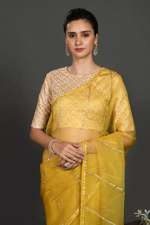 Shop yellow gota work organza sari online in USA with blouse. Make a fashion statement on festive occasions and weddings with designer sarees, designer suits, Indian dresses, Anarkali suits, palazzo suits, designer gowns, sharara suits, embroidered sarees from Pure Elegance Indian fashion store in USA.-closeup