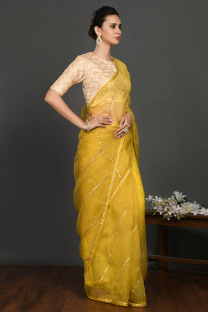 Shop yellow gota work organza sari online in USA with blouse. Make a fashion statement on festive occasions and weddings with designer sarees, designer suits, Indian dresses, Anarkali suits, palazzo suits, designer gowns, sharara suits, embroidered sarees from Pure Elegance Indian fashion store in USA.-right