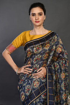 Buy navy blue printed handloom sari online in USA with yellow blouse. Make a fashion statement on festive occasions and weddings with designer sarees, designer suits, Indian dresses, Anarkali suits, palazzo suits, designer gowns, sharara suits, embroidered sarees from Pure Elegance Indian fashion store in USA.-closeup