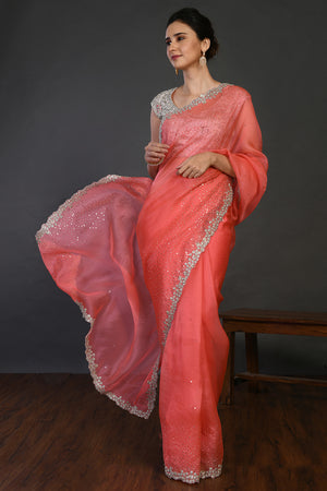 Shop coral cutdana work organza sari online in USA with blouse. Make a fashion statement on festive occasions and weddings with designer sarees, designer suits, Indian dresses, Anarkali suits, palazzo suits, designer gowns, sharara suits, embroidered sarees from Pure Elegance Indian fashion store in USA.-front
