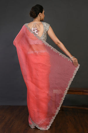 Shop coral cutdana work organza sari online in USA with blouse. Make a fashion statement on festive occasions and weddings with designer sarees, designer suits, Indian dresses, Anarkali suits, palazzo suits, designer gowns, sharara suits, embroidered sarees from Pure Elegance Indian fashion store in USA.-back