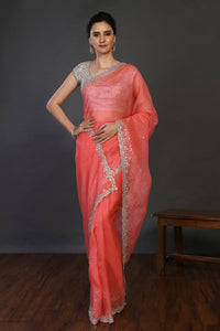 Shop coral cutdana work organza sari online in USA with blouse. Make a fashion statement on festive occasions and weddings with designer sarees, designer suits, Indian dresses, Anarkali suits, palazzo suits, designer gowns, sharara suits, embroidered sarees from Pure Elegance Indian fashion store in USA.-full view
