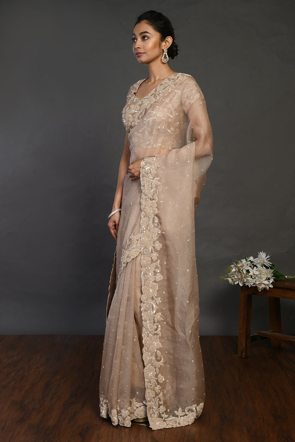 Shop beige embroidered organza sari online in USA with sequin border. Make a fashion statement on festive occasions and weddings with designer sarees, designer suits, Indian dresses, Anarkali suits, palazzo suits, designer gowns, sharara suits, embroidered sarees from Pure Elegance Indian fashion store in USA.-pallu