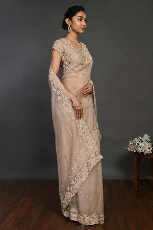 Shop beige embroidered organza sari online in USA with sequin border. Make a fashion statement on festive occasions and weddings with designer sarees, designer suits, Indian dresses, Anarkali suits, palazzo suits, designer gowns, sharara suits, embroidered sarees from Pure Elegance Indian fashion store in USA.-right