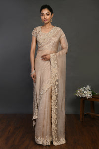 Shop beige embroidered organza sari online in USA with sequin border. Make a fashion statement on festive occasions and weddings with designer sarees, designer suits, Indian dresses, Anarkali suits, palazzo suits, designer gowns, sharara suits, embroidered sarees from Pure Elegance Indian fashion store in USA.-full view