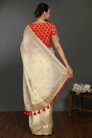 Buy cream hand embroidered organza sari online in USA with red bandhej blouse. Make a fashion statement on festive occasions and weddings with designer sarees, designer suits, Indian dresses, Anarkali suits, palazzo suits, designer gowns, sharara suits, embroidered sarees from Pure Elegance Indian fashion store in USA.-back