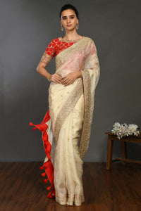 Buy cream hand embroidered organza sari online in USA with red bandhej blouse. Make a fashion statement on festive occasions and weddings with designer sarees, designer suits, Indian dresses, Anarkali suits, palazzo suits, designer gowns, sharara suits, embroidered sarees from Pure Elegance Indian fashion store in USA.-full view