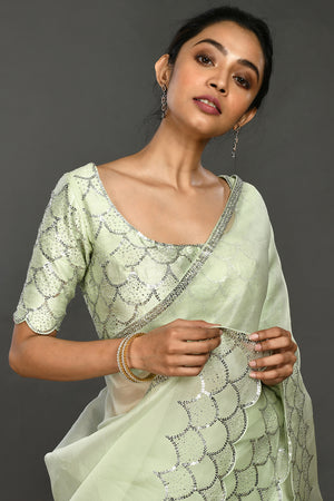 Buy beautiful pista green stone and sequin work organza sari online in USA. Make a fashion statement on festive occasions and weddings with designer sarees, designer suits, Indian dresses, Anarkali suits, palazzo suits, designer gowns, sharara suits, embroidered sarees from Pure Elegance Indian fashion store in USA.-closeup