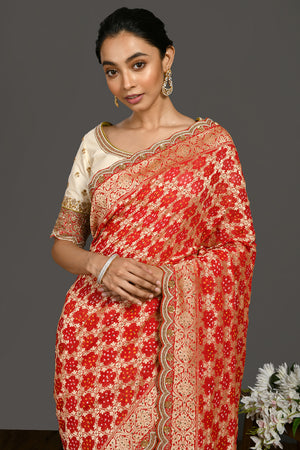 Buy red bandhej pearl work sari online in USA with cream blouse. Make a fashion statement on festive occasions and weddings with designer sarees, designer suits, Indian dresses, Anarkali suits, palazzo suits, designer gowns, sharara suits, embroidered sarees from Pure Elegance Indian fashion store in USA.-closeup