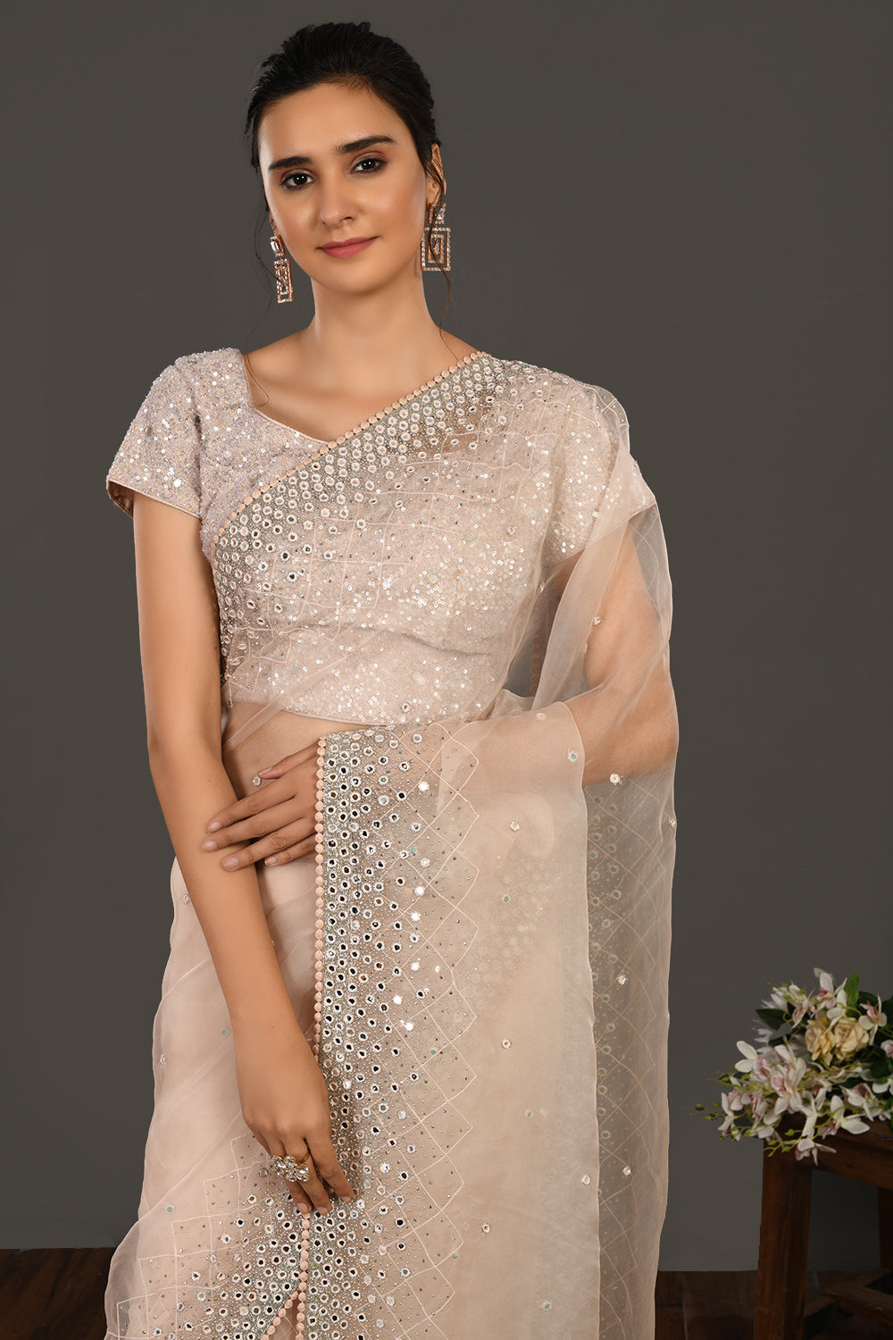 Shop beige mirror work organza sari online in USA with blouse. Make a fashion statement on festive occasions and weddings with designer sarees, designer suits, Indian dresses, Anarkali suits, palazzo suits, designer gowns, sharara suits, embroidered sarees from Pure Elegance Indian fashion store in USA.-closeup