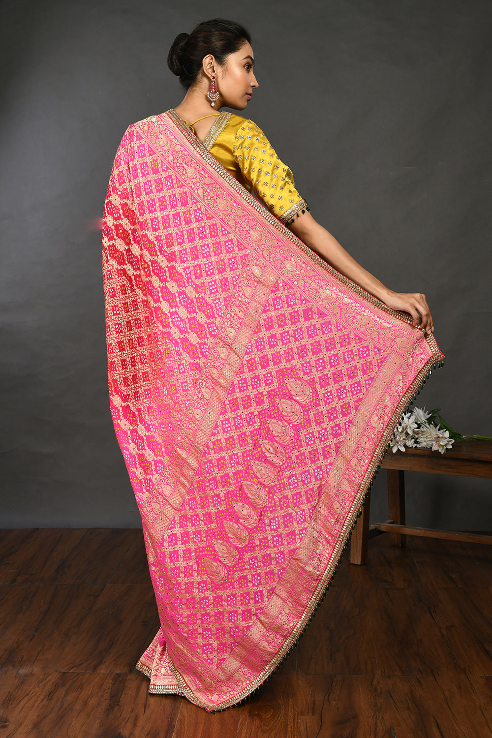 Buy fuschia pink gota and stone work bandhej sari online in USA with blouse. Make a fashion statement on festive occasions and weddings with designer sarees, designer suits, Indian dresses, Anarkali suits, palazzo suits, designer gowns, sharara suits, embroidered sarees from Pure Elegance Indian fashion store in USA.-back